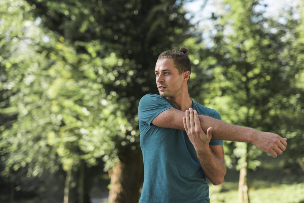 young-man-stretching-park